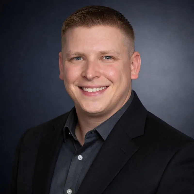 Rendell Rich, Chief Technology Officer of Exceed the Odds, smiling in a dark blazer